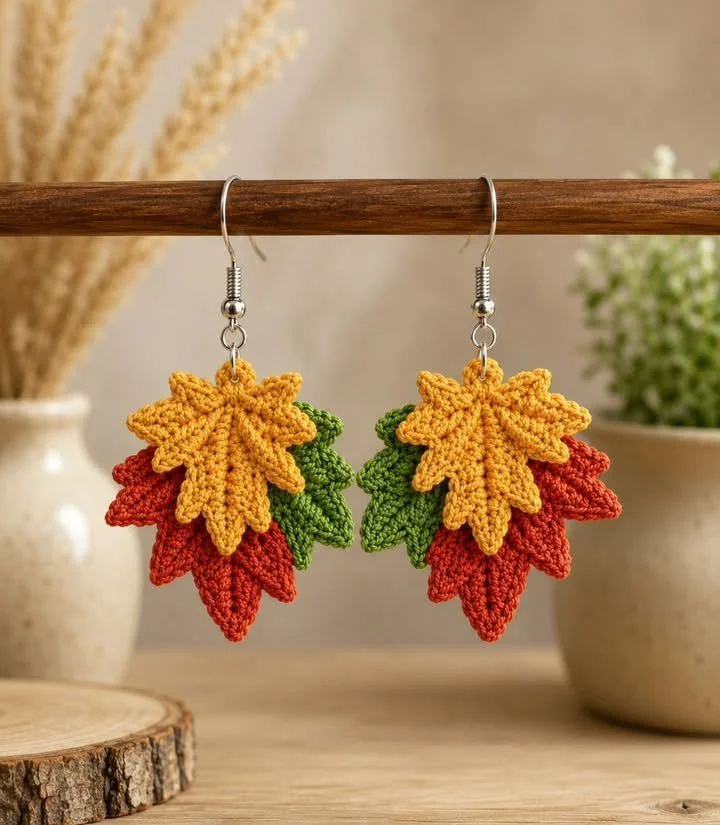 Handmade crochet earrings inspired by nature in warm autumn hues.